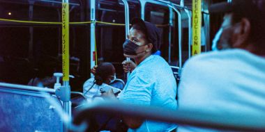 Person with face mask on a bus